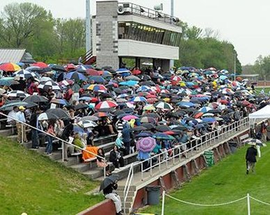 SOGGY DAY: The crowd at Holland Municipal Stadium waiting for Hope College's 2012 Commencement Exercise before storms forced the proceedings to DeVos Fieldhouse on May 6, 2012. (photo courtesy Hope College) SOGGY DAY: The crowd at Holland Municipal Stadium waiting for Hope College's 2012 Commencement Exercise before storms forced the proceedings to DeVos Fieldhouse on May 6, 2012. (photo courtesy Hope College)