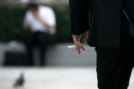 A man holds a cigarette in Tokyo August 3, 2009. REUTERS/Stringer A man holds a cigarette in Tokyo August 3, 2009. REUTERS/Stringer