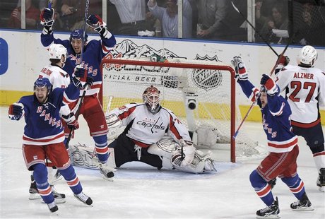 New York Rangers' Derek Stepan (L), Artem Anisimov, and John Mitchell (2nd R) celebrate after Marc Staal, not seen, scored on Washington Cap New York Rangers' Derek Stepan (L), Artem Anisimov, and John Mitchell (2nd R) celebrate after Marc Staal, not seen, scored on Washington Cap