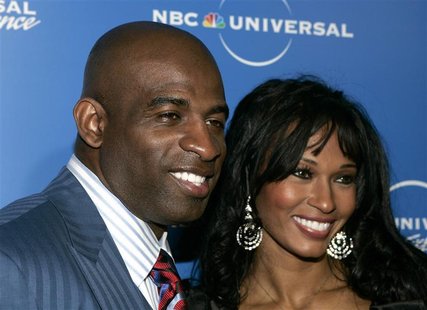 Former NFL player Deion Sanders and his wife Pilar, stars of the Oxygen Network's" "Deion and Pilar: Prime Time Love", arrive at the NBC Uni Former NFL player Deion Sanders and his wife Pilar, stars of the Oxygen Network's" "Deion and Pilar: Prime Time Love", arrive at the NBC Uni