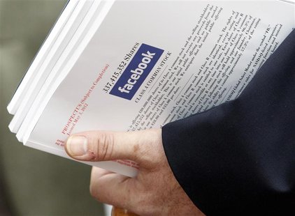 An investor holds prospectus explaining the Facebook stock after attending a show for Facebook Inc's initial public offering at the Four Sea An investor holds prospectus explaining the Facebook stock after attending a show for Facebook Inc's initial public offering at the Four Sea