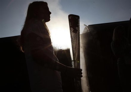 Helana Scott stands with the Olympic torch before boarding a train during the London 2012 Olympic Games Torch Relay rehearsal at Great Centr Helana Scott stands with the Olympic torch before boarding a train during the London 2012 Olympic Games Torch Relay rehearsal at Great Centr
