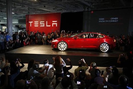 Tesla Motors CEO Elon Musk drives a Model S, the company's first full-size electric sedan, at the Tesla factory in Fremont, California Octob Tesla Motors CEO Elon Musk drives a Model S, the company's first full-size electric sedan, at the Tesla factory in Fremont, California Octob