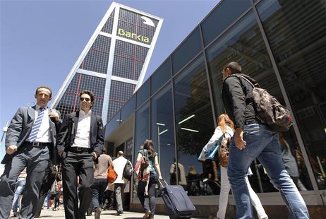 People walk past the Bankia headquarters tower in Madrid May 9, 2012. Shares in Spain's fourth largest lender, Bankia, fell a further 6 perc People walk past the Bankia headquarters tower in Madrid May 9, 2012. Shares in Spain's fourth largest lender, Bankia, fell a further 6 perc