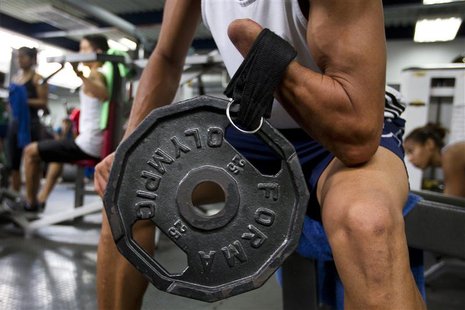Willy Martinez, 27, a member of the Venezuelan Paralympics team, lifts weights during training in Caracas April 24, 2012. REUTERS/Carlos Gar Willy Martinez, 27, a member of the Venezuelan Paralympics team, lifts weights during training in Caracas April 24, 2012. REUTERS/Carlos Gar