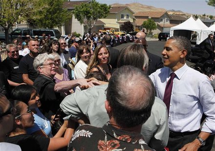 U.S. President Barack Obama shakes hands with residents following a speech after meeting with homeowners Val and Paul Keller to discuss the U.S. President Barack Obama shakes hands with residents following a speech after meeting with homeowners Val and Paul Keller to discuss the