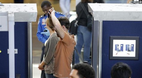 A man is screened with a backscatter x-ray machine at a TSA security checkpoint in terminal 4 at LAX, Los Angeles International Airport, in A man is screened with a backscatter x-ray machine at a TSA security checkpoint in terminal 4 at LAX, Los Angeles International Airport, in