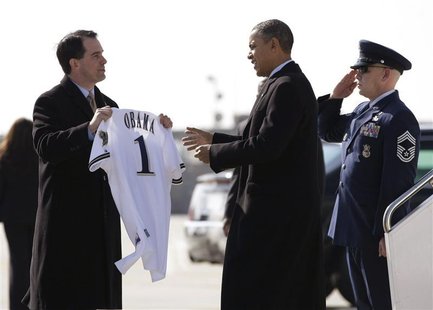 Wisconsin Governor Scott Walker presents U.S. President Barack Obama with a Milwaukee Brewers jersey upon his arrival in Milwaukee, Wisconsi Wisconsin Governor Scott Walker presents U.S. President Barack Obama with a Milwaukee Brewers jersey upon his arrival in Milwaukee, Wisconsi