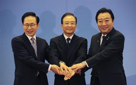 South Korea's President Lee Myung-bak (L), China's Premier Wen Jiabao (C) and Japan's Prime Minister Yoshihiko Noda hold their hands togethe South Korea's President Lee Myung-bak (L), China's Premier Wen Jiabao (C) and Japan's Prime Minister Yoshihiko Noda hold their hands togethe