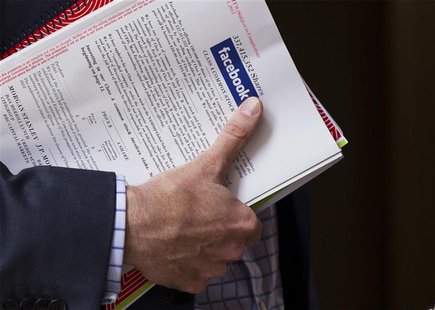 A man stands outside of the St. Regis hotel holding a pamphlet of information on investing in the upcoming IPO of Facebook in New York May 1 A man stands outside of the St. Regis hotel holding a pamphlet of information on investing in the upcoming IPO of Facebook in New York May 1