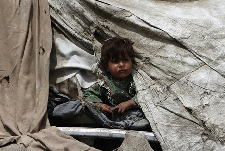 An internally displaced Afghan girl looks out from her shelter at a refugee camp in Kabul May 9, 2012. REUTERS/Mohammad Ismail An internally displaced Afghan girl looks out from her shelter at a refugee camp in Kabul May 9, 2012. REUTERS/Mohammad Ismail