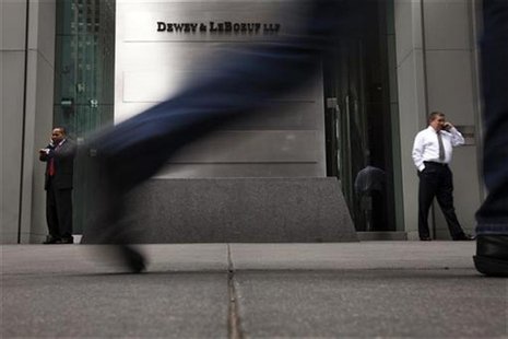 Pedestrians walk past a sign outside of the building housing the law firm Dewey & LeBoeuf LLP in New York, May 8, 2012. REUTERS/Lucas Jackso Pedestrians walk past a sign outside of the building housing the law firm Dewey & LeBoeuf LLP in New York, May 8, 2012. REUTERS/Lucas Jackso