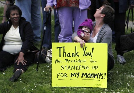 A sign on the side of the road reads "Thank You! Mr. President for standing up for my mommys!" as President Barack Obama's motorcade rolls t A sign on the side of the road reads "Thank You! Mr. President for standing up for my mommys!" as President Barack Obama's motorcade rolls t
