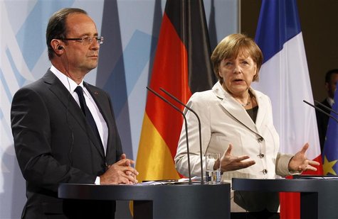 German Chancellor Angela Merkel and French President Francois Hollande address a news conference after their talks in the Chancellery in Ber German Chancellor Angela Merkel and French President Francois Hollande address a news conference after their talks in the Chancellery in Ber
