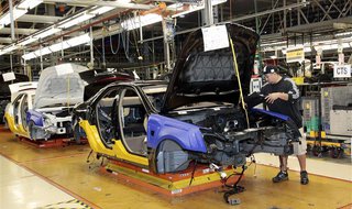 A General Motors assembly worker works on the production line for the 2011 Cadillac at the Grand River Assembly plant in Lansing, Michigan O A General Motors assembly worker works on the production line for the 2011 Cadillac at the Grand River Assembly plant in Lansing, Michigan O