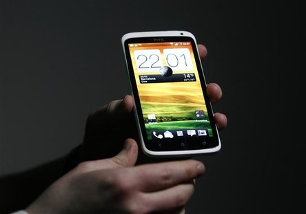 A man holds up the new HTC One after a news conference at the Mobile World Congress in Barcelona February 26, 2012. REUTERS/Gustau Nacarino A man holds up the new HTC One after a news conference at the Mobile World Congress in Barcelona February 26, 2012. REUTERS/Gustau Nacarino