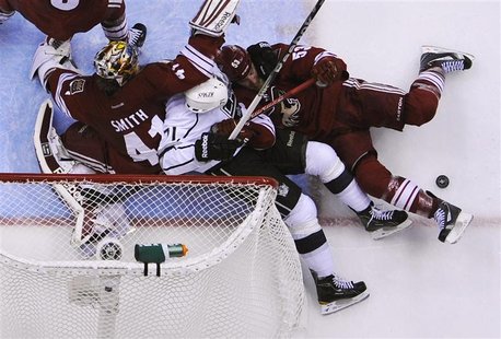 Los Angeles Kings' Jordan Nolan (C) and Phoenix Coyotes' Derek Morris (R) battle for the puck while sliding into Coyotes' goalie Mike Smith Los Angeles Kings' Jordan Nolan (C) and Phoenix Coyotes' Derek Morris (R) battle for the puck while sliding into Coyotes' goalie Mike Smith