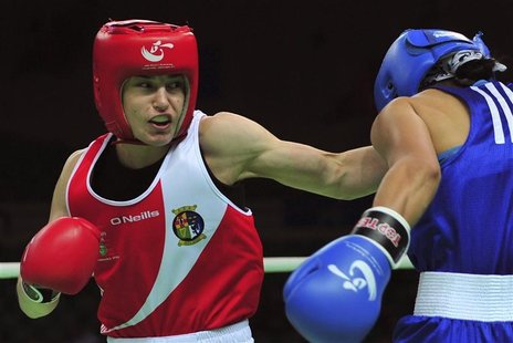 Katie Taylor (L) of Ireland throws a punch at Saida Khassenova of Kazakhstan during their women's 60 kg division fourth round match at the A Katie Taylor (L) of Ireland throws a punch at Saida Khassenova of Kazakhstan during their women's 60 kg division fourth round match at the A