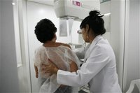 A woman undergoes a free mammogram inside Peru's first mobile unit for breast cancer detection, in Lima March 8, 2012. REUTERS/Enrique Castr
