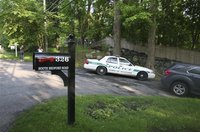 A police car guards the driveway of the home of Mary Kennedy in Bedford, New York May 16, 2012. REUTERS/Michelle McLoughlin