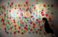 A woman walks past the Google Chicago headquarters logo in Chicago, March 20, 2012. REUTERS/Jim Young