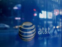 Reflections are seen in the window of an AT&T store in New York March 21, 2011. REUTERS/Brendan McDermid