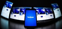 The loading screen of the Facebook application on a mobile phone is seen in this photo illustration taken in Lavigny May 16, 2012. REUTERS/V