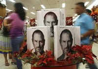 Customers walk past a display of the biography of Steve Jobs, sold at a bookstore in Quezon City, Metro Manila October 24, 2011. REUTERS/Che
