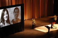 USC (University of Southern California) president C. L. Max Nikias bows before images of Chinese murder victims Ying Wu and Ming Qu before e