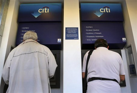 Two men withdraw money from an ATM in central Athens May 16, 2012. REUTERS/Yannis Behrakis Two men withdraw money from an ATM in central Athens May 16, 2012. REUTERS/Yannis Behrakis