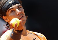 Rafael Nadal of Spain serves the ball to Tomas Berdych of Czech Republic during their match at the Rome Masters tennis tournament May 18, 20
