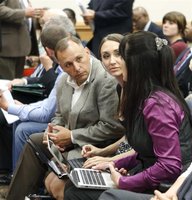 Tea Party members Kurt Potter, Rachael Proctor and Mishelle Perkins (L-R) discuss strategy as they wait for a committee meeting to start in 