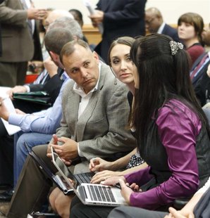Tea Party members Kurt Potter, Rachael Proctor and Mishelle Perkins (L-R) discuss strategy as they wait for a committee meeting to start in Tea Party members Kurt Potter, Rachael Proctor and Mishelle Perkins (L-R) discuss strategy as they wait for a committee meeting to start in