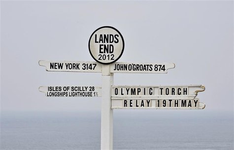 The sign at Lands End is seen with an Olympic Torch Relay directional marker, in Cornwall, south west England May 18, 2012. The London 2012 The sign at Lands End is seen with an Olympic Torch Relay directional marker, in Cornwall, south west England May 18, 2012. The London 2012