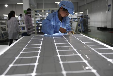 An employee works on a solar panel production line at a solar company workshop in Yongkang, Zhejiang province February 23, 2012. REUTERS/Str An employee works on a solar panel production line at a solar company workshop in Yongkang, Zhejiang province February 23, 2012. REUTERS/Str