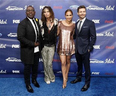 Judges Randy Jackson (L), Steven Tyler (2nd L), Jennifer Lopez and show host Ryan Seacrest pose at the party for the finalists of the televi Judges Randy Jackson (L), Steven Tyler (2nd L), Jennifer Lopez and show host Ryan Seacrest pose at the party for the finalists of the televi
