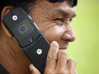 A man uses his Motorola mobile phone in Bangkok August 16, 2011. REUTERS/Chaiwat Subprasom