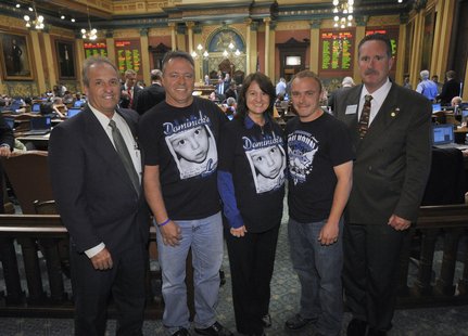 tate Reps. Joe Graves (left) and Matt Lori (right) on the House floor with Dominick Calhoun’s family (Rick, Judy and Eric Calhoun) following the unanimous passage of Dominick’s law by the Michigan House. tate Reps. Joe Graves (left) and Matt Lori (right) on the House floor with Dominick Calhoun’s family (Rick, Judy and Eric Calhoun) following the unanimous passage of Dominick’s law by the Michigan House.