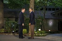U.S. President Barack Obama (R) greets Britain's Prime Minister David Cameron as he arrives at the G8 Summit at Camp David, Maryland May 18,