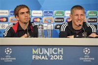 Philipp Lahm and Bastian Schweinsteiger (R) smile during the Bayern Munich news conference, ahead of the Champions League final soccer match