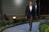 President Barack Obama walks to welcome guests at the G8 summit in Camp David, May 18, 2012. REUTERS/Philippe Wojazer