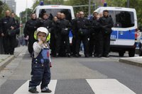 A child stands in front of German riot police officers during an anti-austerity demonstration in Frankfurt May 19, 2012. REUTERS/Alex Domans