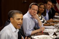 Britain's Prime Minister David Cameron listens as U.S. President Barack Obama (L) speaks during an expanded G8 working luncheon with leaders