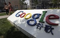 Women walk past the logo of Google in front of its former headquarters, in Beijing June 2, 2011. REUTERS/Jason Lee