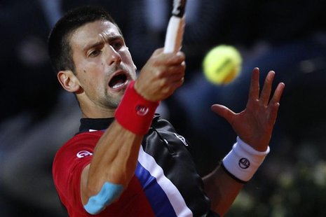 Novak Djokovic of Serbia returns the ball to Roger Federer of Switzerland during their semi-final match at the Rome Masters tennis tournamen Novak Djokovic of Serbia returns the ball to Roger Federer of Switzerland during their semi-final match at the Rome Masters tennis tournamen