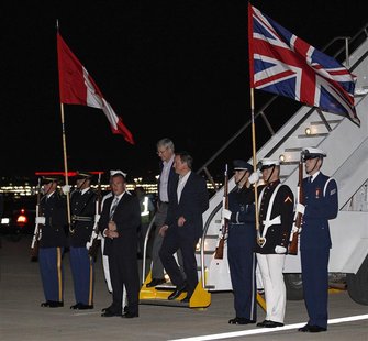 Canada's Prime Minister Stephen Harper (L) and Britain's Prime Minister David Cameron disembark from Harper's plane after arriving in Chicag Canada's Prime Minister Stephen Harper (L) and Britain's Prime Minister David Cameron disembark from Harper's plane after arriving in Chicag