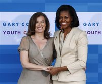U.S. First Lady Michelle Obama (R) greets Valerie Trierweiler, companion of France's President Francois Hollande, before a tour of the Gary 