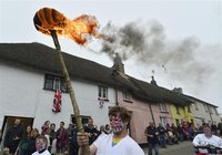 Crowds line the streets as a locally organised torch relay race is run ahead of the Olympic Torch Relay in Hatherleigh in south west England