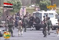 A still image taken from video shows army personnel helping injured soldier at the scene of a suicide attack in Sanaa May 21, 2012. REUTERS/