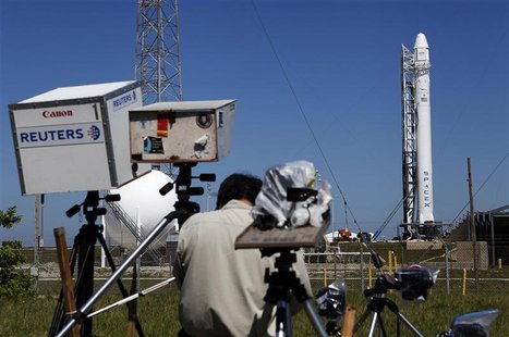 News photographers work on their remote cameras as the SpaceX Falcon 9 test rocket is being prepared for a second launch attempt from Space News photographers work on their remote cameras as the SpaceX Falcon 9 test rocket is being prepared for a second launch attempt from Space